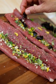 Swabian cuisine, preparation of lamb with prunes, raw lamb stuffed with herbs, rosemary, sliced