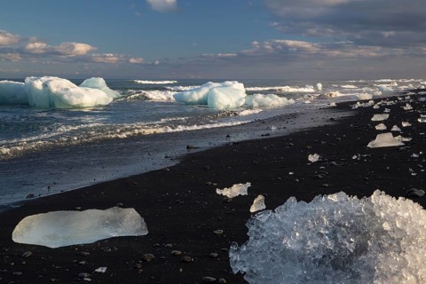 Little icebergs and crushed ice on the black beach at Joekulsarlon glacial lake