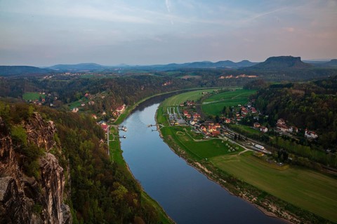 Elbe river at dawn seen from the Bastei rocks near the village of Rathen in Saxon Switzerland