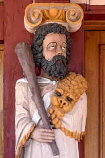 Atlant, figure of the god Hercules, colourfully painted carving on the portal to the town hall,