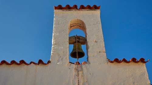 Close-up of a bell tower with a bell under a blue sky, Agios Ioannis church, Mesochori village,
