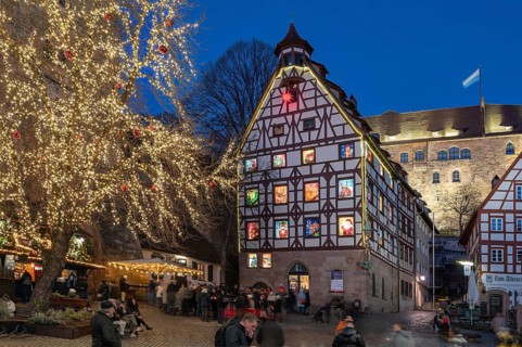 Historic Pilatus House with an Advent calendar designed by the Altstadtfreuden Nuremberg, behind