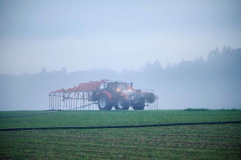 Farmer with tractor fertilising, Rottenschwil, Canton Aargau, Switzerland, Europe
