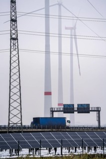 Wind farm in the fog, photovoltaic system, on the A44 motorway, dark doldrums, no wind no direct