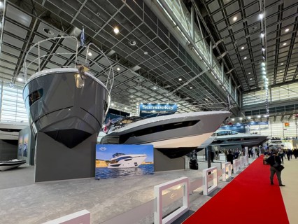 View of bow of Sunseeker luxury yachts superyachts ships boats in exhibition hall of public fair