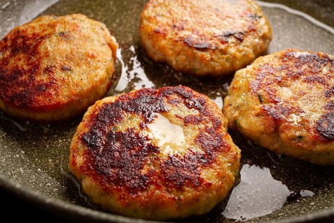Fried chicken cutlets, with vegetables, in a frying pan, homemade, no people