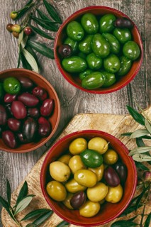 A mixture of olives, varieties of chalkidiki, Verdi giganti and Kalamata, in a bowl, top view, no