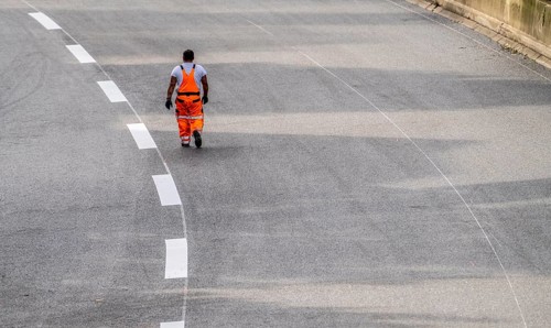 Marking work after the application of new whisper asphalt surface for the A40 motorway, in the