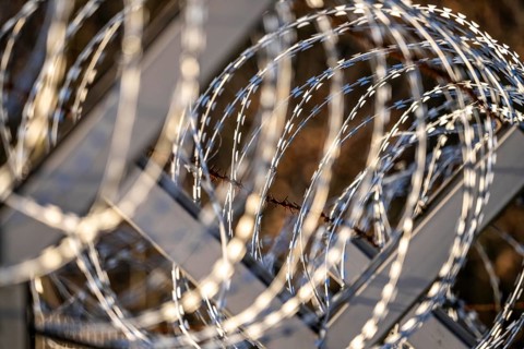 Symbolic image security, S-wire rolls, NATO wire, on a fence top, demarcation of a property,