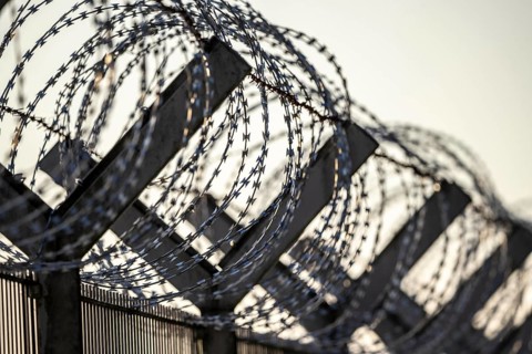 Symbolic image security, S-wire rolls, NATO wire, on a fence top, demarcation of a property,