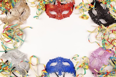 Colourful masks and paper snakes on a white background, carnival atmosphere