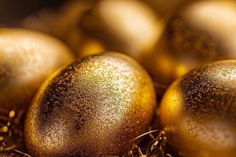 Close up of shiny golden easter eggs with glitter. Generative AI, AI generated