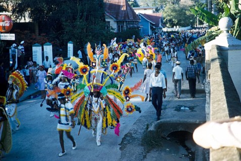 People in colourful costumes at the carnival parade, Port of Spain, Trinidad 1963 with the title