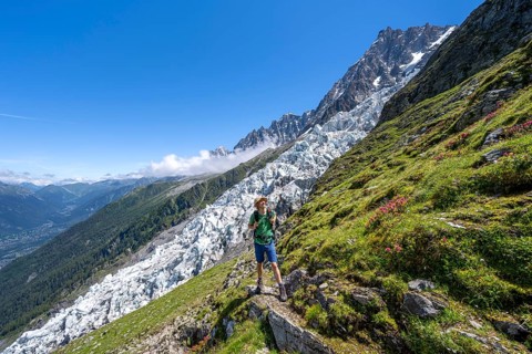 Hiking on the trail to La Jonction, Glacier des Bossons, behind the summit of the Aiguille du Midi,