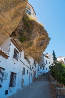 Street in Setenil de las Bodegas with overhanging rock, sunny, cave dwellings, Setenil de las