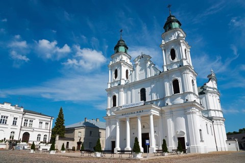 Historic white baroque-style church against a blue sky, Basilica of the Nativity of the Virgin
