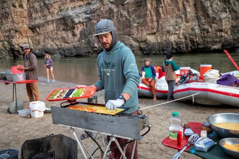 Dinosaur, Colorado, River guide Sam Crittenden cooks breakfast for river rafters on the Green River