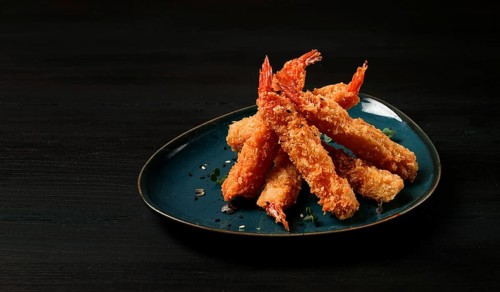 Fried shrimp, peeled in tempura, soy sauce, close-up