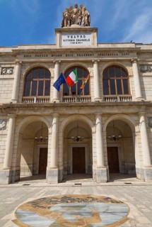Vittorio Emanuele Theatre building facade with three arched entrance and 1908-2008 commemorative