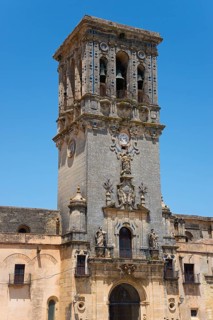 Historic bell tower with intricate sculptures, a clock and detailed stonework, Basilica Santa María