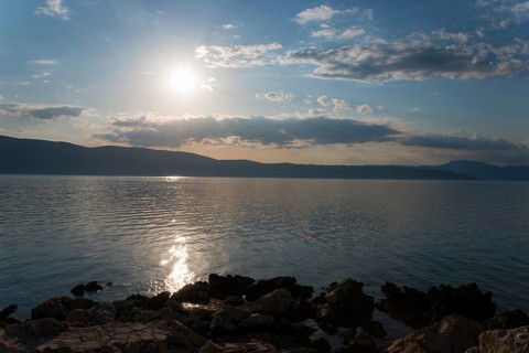 Sunny sky over a calm sea with reflecting sunlight, Glavotok, island of Krk, Primorje-Gorski kotar,