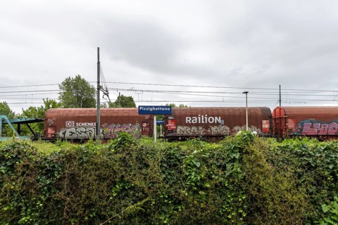 Railway station, Stazione di Pizzighettone with a goods train operated by the logistics company