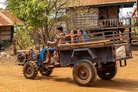 Children on a two-wheel tractor in the village of Ban Baktheung in the Bolaven Plateau, Laos, Asia