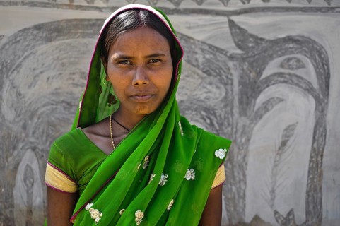 Portrait of a hindu woman. Khovar art in the background. Hazaribagh district, Jharkhand, India. The