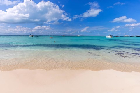 Serene turquoise Isla Mujeres beach Playa Norte famous for emerald waters, sandy sea shore and
