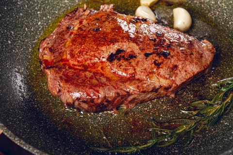 Fried steak, beef steak, rib eye steak, in a frying pan, top view, no people