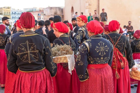 Traditionally dressed Greek women carrying gifts during marriage celebration, Chania, Crete, Greek