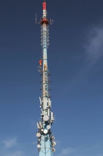 Mobile phone communications tower with antennas against blue sky, Mount Srd, Dubrovnik, Croatia,