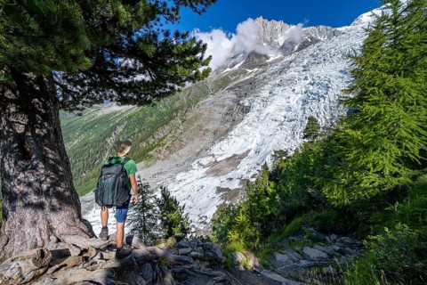 Mountaineer in front of impressive mountain landscape with glacier, view of Glacier des Bossons and