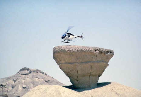 Bell 206 JetRanger helicopter landing on a rocky outcrop Arabian Desert, Saudi Arabia Oil industry