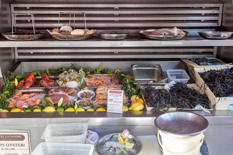 A market stall presents a variety of fresh seafood and oysters, Paris