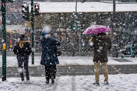 Winter weather, heavy snowfall, city centre traffic, passers-by in the snow, North