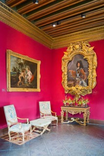Baroque room with elaborate portraits and gold-framed paintings on red walls, Louis XIV Salon,