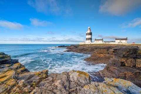 Hook Head lighthouse, blue sky and spray, Wexford, Ireland, Europe