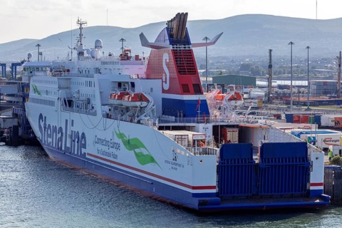 Large ferry in the harbour ready for loading or unloading surrounded by industrial plants, Belfast