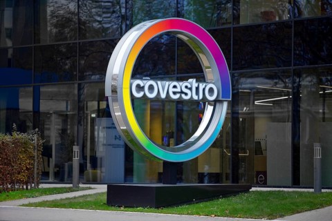 Covestro AG, company logo in front of the corporate headquarters at dusk, Leverkusen, Bergisches
