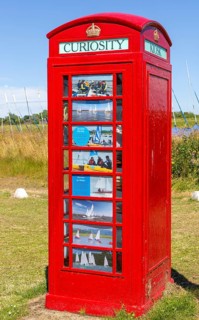 Red K6 telephone box repurposed as local curiosity information booth, Felixstowe Ferry, Suffolk,