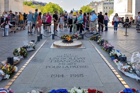 Monument with floral wreaths and people in honour of a fallen soldier in Paris, Paris
