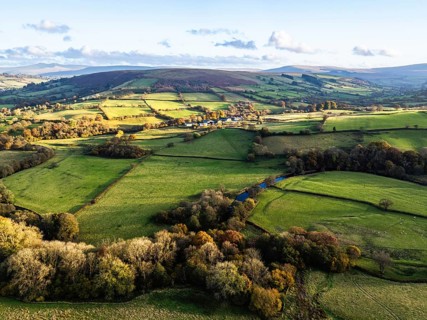 Farms over Trecastle from a drone at sunset, Brecon Beacons National Park, Powys, Wales, England,