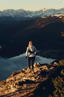 Trail running in autumn on the Jochberg on Lake Walchensee against the wonderful backdrop of the