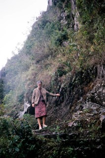 Female tourist descending the steep mountain path Huayna Picchu, Machu Picchu, Peru, South America
