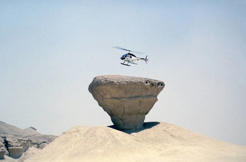 Bell 206 JetRanger helicopter landing on a rocky outcrop Arabian Desert, Saudi Arabia Oil industry