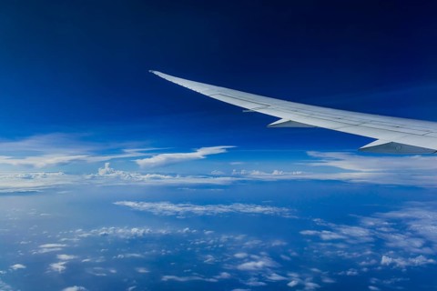 View from the aircraft window during a flight over India with the airline Etihad. Blue sky and