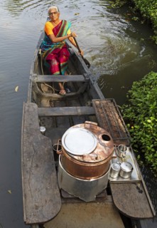 Tealady, 83 years old, paddling in her boat through the backwaters, Kumarakom, Kerala, India, Asia