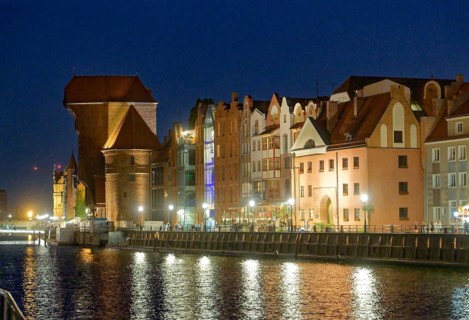 The crane gate, left, with its striking shape, built of brick and wood, in the evening-lit harbour