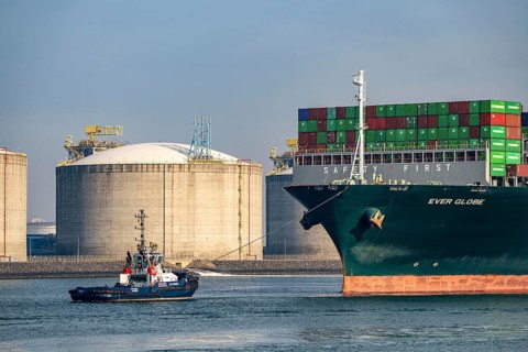 LNG import terminal tanks for liquefied natural gas in the seaport of Rotterdam, harbour tug brings
